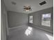 Bright bedroom featuring modern ceiling fan, neutral paint and ample natural light streaming through two windows at 383 Yeager St, Port Charlotte, FL 33954