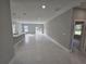 A spacious living room area featuring white tile flooring, recessed lighting, and glass sliding doors at 383 Yeager St, Port Charlotte, FL 33954