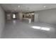 Open-concept living room showcases durable tile floors, ample natural light, and a seamless flow into the kitchen at 383 Yeager St, Port Charlotte, FL 33954