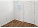 Clean entryway showcasing a white door, a window with blinds, and wood-look flooring at 6171 Calle Ochoa St, Zephyrhills, FL 33542