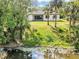 Backyard view of modern home near pond and trees at 82 Venango St, Port Charlotte, FL 33954
