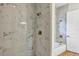 Bathroom featuring stand up shower and tub with matching marble tile and bronze fixtures at 82 Venango St, Port Charlotte, FL 33954