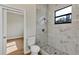 Bathroom features marble tiled shower with black trim window for natural light at 82 Venango St, Port Charlotte, FL 33954