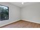 Bright bedroom with wood-look floors, neutral walls and a large window at 82 Venango St, Port Charlotte, FL 33954
