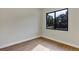 Cozy bedroom with wood-look flooring and a view to the outside greenery at 82 Venango St, Port Charlotte, FL 33954