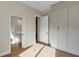 Bedroom featuring wood-look floors, closet, and connected bath area at 82 Venango St, Port Charlotte, FL 33954