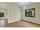 Bedroom with wood flooring and large windows with backyard views and modern light fixture at 82 Venango St, Port Charlotte, FL 33954