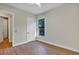 Bedroom with wood-look floors, large window, and closet/bathroom access at 82 Venango St, Port Charlotte, FL 33954