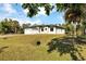 Spacious single-Gathering home with a two-car garage, surrounded by mature trees and lush greenery at 82 Venango St, Port Charlotte, FL 33954
