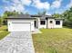 Stunning modern single-Gathering home with a two-car garage, landscaped yard, and a beautiful brick driveway at 82 Venango St, Port Charlotte, FL 33954