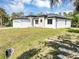 Front exterior showing modern elevation with white stucco and a two car garage at 82 Venango St, Port Charlotte, FL 33954