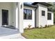Stylish front door and exterior showcasing modern design with clean lines and neat landscaping at 82 Venango St, Port Charlotte, FL 33954