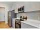 Modern kitchen featuring stainless steel appliances and gray cabinets and countertops at 82 Venango St, Port Charlotte, FL 33954