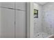 Bathroom featuring stand up shower with window and matching marble tile at 82 Venango St, Port Charlotte, FL 33954