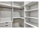 Bright walk-in closet with shelving, drawers and racks for clothing organization at 82 Venango St, Port Charlotte, FL 33954