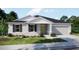 Charming single-story home with a well-manicured lawn and a two-car garage at 22492 Provance Ave, Port Charlotte, FL 33954