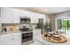 Bright kitchen featuring granite countertops, stainless appliances, and ample cabinet space at 22492 Provance Ave, Port Charlotte, FL 33954