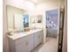 Bright bathroom with double sink vanity and granite countertops, adjacent to the main bedroom at 5048 Silver Bell Dr, Port Charlotte, FL 33948