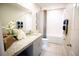 The bathroom features a single sink vanity, tub shower, and neutral colors for a clean, modern look at 5048 Silver Bell Dr, Port Charlotte, FL 33948