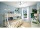 A charming bedroom features a bunk bed, playful decor, and a bright, airy feel at 5048 Silver Bell Dr, Port Charlotte, FL 33948