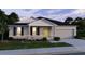 Charming single-story home with a manicured lawn and a welcoming facade at 5048 Silver Bell Dr, Port Charlotte, FL 33948
