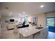 Modern kitchen with granite countertops overlooking a spacious living area at 5048 Silver Bell Dr, Port Charlotte, FL 33948