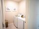 The well-lit laundry room offers a side-by-side washer and dryer at 5048 Silver Bell Dr, Port Charlotte, FL 33948