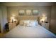 This bedroom features neutral walls, carpet, and a luxurious bed with a tufted headboard and matching side tables at 5048 Silver Bell Dr, Port Charlotte, FL 33948