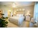 This bright bedroom features neutral walls, carpet, and a luxurious bed with a tufted headboard at 5048 Silver Bell Dr, Port Charlotte, FL 33948