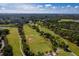 Stunning aerial view of the golf course with lush fairways, mature trees, and blue skies at 1000 Cove Cay Dr # 5E, Clearwater, FL 33760