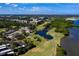 Expansive aerial view of the golf course, surrounding greenery, water and nearby residential buildings at 1000 Cove Cay Dr # 5E, Clearwater, FL 33760