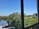 Balcony view showcasing the lush greenery, Intracoastal waterway, and the building's surroundings at 1000 Cove Cay Dr # 5E, Clearwater, FL 33760
