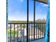 Balcony view featuring tropical landscaping, pool, and canal at 1000 Cove Cay Dr # 5E, Clearwater, FL 33760