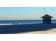 Seaside view featuring a lifeguard station and picnic bench, offering a serene coastal lifestyle at 1000 Cove Cay Dr # 5E, Clearwater, FL 33760