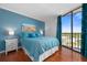 A stylish bedroom with a king-size bed and a view of the outdoors at 1000 Cove Cay Dr # 5E, Clearwater, FL 33760