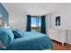 Bright main bedroom featuring a large window with views and a white dresser at 1000 Cove Cay Dr # 5E, Clearwater, FL 33760