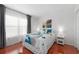 Bedroom with wood floors and large windows with sheer curtains at 1000 Cove Cay Dr # 5E, Clearwater, FL 33760