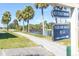 Scenic view of community featuring a lake with a bridge, palm trees, and a snack area at 1000 Cove Cay Dr # 5E, Clearwater, FL 33760