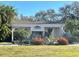 Exterior view of the clubhouse entrance with lush tropical landscaping at 1000 Cove Cay Dr # 5E, Clearwater, FL 33760