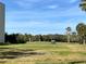 Picturesque golf course with manicured greens and palm trees under a clear blue sky at 1000 Cove Cay Dr # 5E, Clearwater, FL 33760