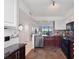 Well-lit kitchen with granite counters, tile backsplash, and views to the dining area and the outdoors at 1000 Cove Cay Dr # 5E, Clearwater, FL 33760