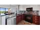 Updated kitchen featuring granite counters, stainless steel appliances, and breakfast bar with views to living spaces at 1000 Cove Cay Dr # 5E, Clearwater, FL 33760