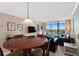 Open-concept living and dining area with access to a balcony offering scenic views at 1000 Cove Cay Dr # 5E, Clearwater, FL 33760