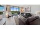 Inviting living room with tile floors, modern furniture, and sliding glass doors to the balcony at 1000 Cove Cay Dr # 5E, Clearwater, FL 33760