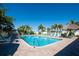 Inviting pool area with plenty of lounge chairs and tiki huts surrounded by lush, tropical landscaping at 1000 Cove Cay Dr # 5E, Clearwater, FL 33760