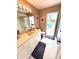 En suite bathroom offers a vanity with a single sink and access to the pool area at 1727 Waxwing Cir, Venice, FL 34293