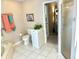 Full bathroom with tile floors, soaking tub, toilet, and walk-in shower at 1727 Waxwing Cir, Venice, FL 34293