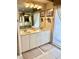 Bathroom featuring double sinks, marble countertops, and ample storage space at 1727 Waxwing Cir, Venice, FL 34293