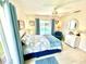 Bright bedroom featuring a ceiling fan, tile floors, and a view of the pool at 1727 Waxwing Cir, Venice, FL 34293