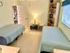 Light filled bedroom featuring two beds, ceiling fan and view to next room at 1727 Waxwing Cir, Venice, FL 34293